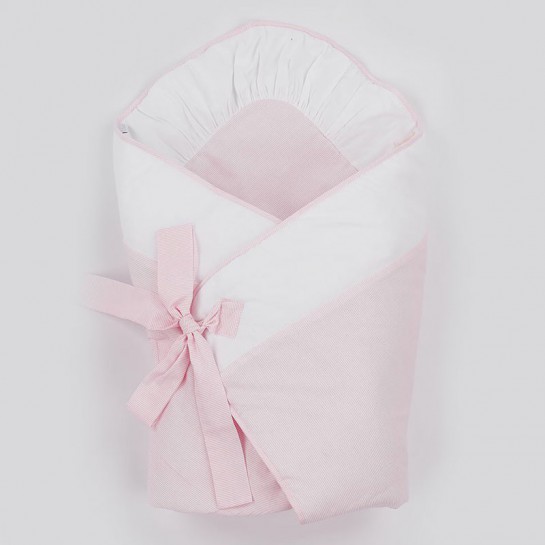 A white and pink baby swaddling wrap