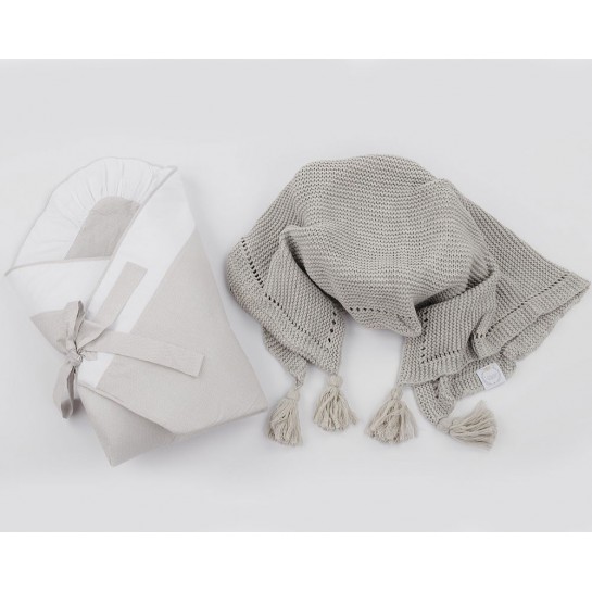 A grey baby swaddling wrap with a grey scented blanket