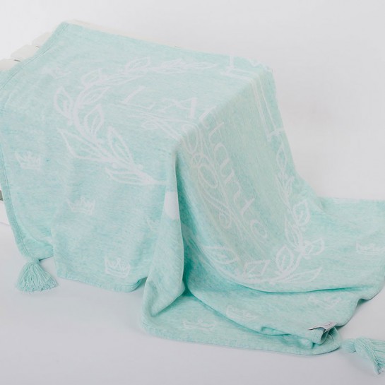 A woven, mint blanket (throw)
