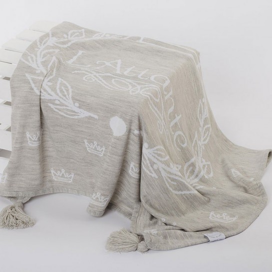 A woven, light gray blanket (throw)